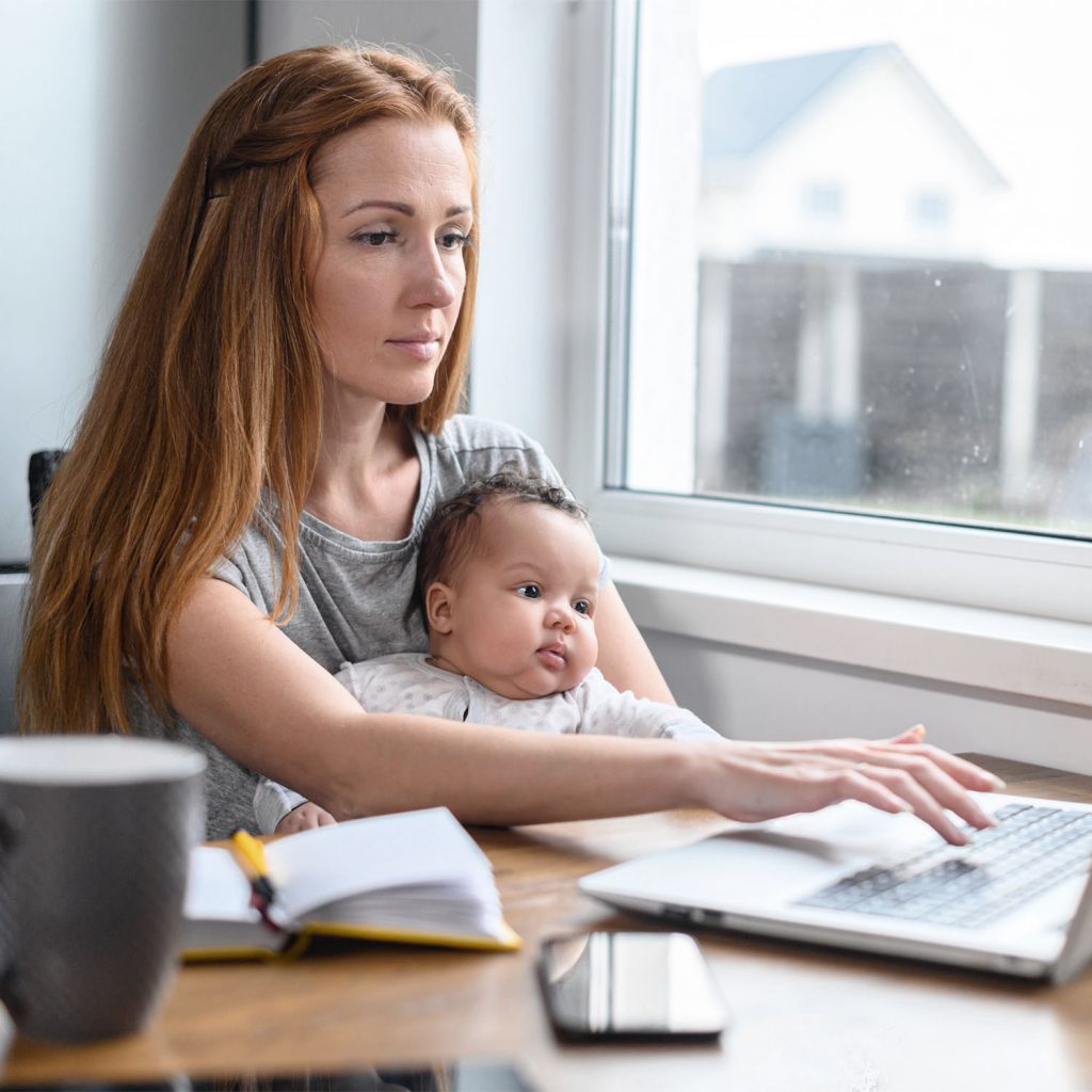 woman on computer with baby on lap